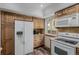 Well-equipped kitchen boasts stainless steel appliances, wood cabinets, and modern flooring, perfect for culinary enthusiasts at 6119 Zenobia Ct, Arvada, CO 80003