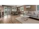 Living and dining area with hardwood floors, natural light, and stylish furniture at 6119 Zenobia Ct, Arvada, CO 80003