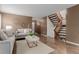 Inviting living space with hardwood floors, staircase, and comfortable seating at 6119 Zenobia Ct, Arvada, CO 80003