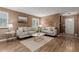 Cozy living room features hardwood floors, comfortable seating, and neutral paint at 6119 Zenobia Ct, Arvada, CO 80003
