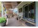 Covered outdoor patio featuring furniture, privacy screening, and access to the home at 6119 Zenobia Ct, Arvada, CO 80003