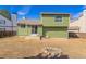 Backyard featuring a green home, a fire pit and grassy area at 616 N Brentwood Ct, Castle Rock, CO 80104