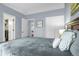 A bedroom with soft gray walls, carpet, and natural light peering through the doorway at 616 N Brentwood Ct, Castle Rock, CO 80104