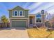 Charming two-story home with an attached two-car garage, a stone facade, and mature landscaping at 616 N Brentwood Ct, Castle Rock, CO 80104