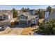 View of a green two-story home with a two-car garage, landscaped front yard, and mature trees at 616 N Brentwood Ct, Castle Rock, CO 80104