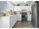 Well-lit kitchen with white cabinets, modern appliances, and a sink overlooking the garden at 616 N Brentwood Ct, Castle Rock, CO 80104
