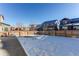 Large backyard with snow and wooden fence at 3912 Trail Stone Cir, Castle Rock, CO 80108