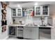 Basement wet bar with wine cooler and beverage tap at 3912 Trail Stone Cir, Castle Rock, CO 80108