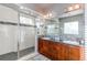 Large bathroom with double sinks, walk-in shower, and modern cabinetry at 3912 Trail Stone Cir, Castle Rock, CO 80108
