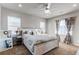 Spacious bedroom with a large bed, window, and ceiling fan at 3912 Trail Stone Cir, Castle Rock, CO 80108
