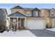 Two-story house with attached garage, stone accents, and a welcoming front porch at 3912 Trail Stone Cir, Castle Rock, CO 80108