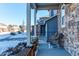 Cozy front porch with wicker chair and planters, offering a relaxing outdoor space at 3912 Trail Stone Cir, Castle Rock, CO 80108
