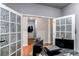 Home office with French doors and view into hallway at 3912 Trail Stone Cir, Castle Rock, CO 80108