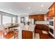 Bright kitchen with island, hardwood floors, and stainless steel appliances at 3912 Trail Stone Cir, Castle Rock, CO 80108
