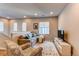 Bright loft area with seating, a TV and hardwood floors at 3912 Trail Stone Cir, Castle Rock, CO 80108