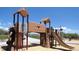 Wooden playground structure with a slide and climbing area at 3912 Trail Stone Cir, Castle Rock, CO 80108