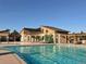 Community pool with lounge chairs and adjacent clubhouse at 3912 Trail Stone Cir, Castle Rock, CO 80108