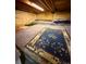 Unfinished basement with concrete floors and low ceiling, featuring area rugs at 33606 Gap Rd, Golden, CO 80403
