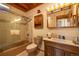 Cozy bathroom featuring a shower, bathtub, vanity, and wooden cabinets at 33606 Gap Rd, Golden, CO 80403