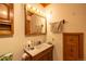 Bathroom features wood vanity with ample storage, medicine cabinet, and neutral color scheme at 33606 Gap Rd, Golden, CO 80403