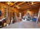 Garage featuring exposed wood framing, concrete floor and storage at 33606 Gap Rd, Golden, CO 80403