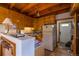 This kitchen boasts wooden cabinets, a wooden ceiling, tile backsplash, and stainless steel appliances at 33606 Gap Rd, Golden, CO 80403