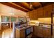 This kitchen boasts wooden cabinets, tile backsplash, a wooden ceiling, and stainless steel appliances at 33606 Gap Rd, Golden, CO 80403