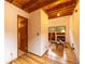 A living room area with hardwood floors, windows, and a doorway at 33606 Gap Rd, Golden, CO 80403