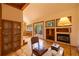 A living room area with hardwood floors, built-in shelves, a fireplace, and windows at 33606 Gap Rd, Golden, CO 80403