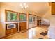 A living room area with hardwood floors, many windows, and built-in features at 33606 Gap Rd, Golden, CO 80403
