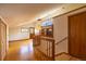 Open living space featuring hardwood floors, a staircase, wood railings, and a large window at 33606 Gap Rd, Golden, CO 80403