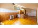 Spacious loft area with wood paneled wall, natural light, and hardwood flooring at 33606 Gap Rd, Golden, CO 80403