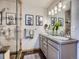 Bathroom featuring dual sinks, modern fixtures, granite counters, and glass shower at 32663 Donna Dr, Conifer, CO 80433