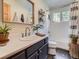 Charming bathroom featuring a modern vanity, patterned shower curtain and bright natural light at 32663 Donna Dr, Conifer, CO 80433