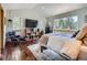 Bright, airy bedroom with hardwood floors, comfortable seating, and views of the surrounding trees at 32663 Donna Dr, Conifer, CO 80433