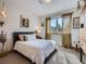 Bright bedroom featuring a black bed frame, neutral color palette, and decorative curtains at 32663 Donna Dr, Conifer, CO 80433