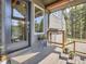 Stylish porch featuring a glass door, wood railings and potted plants at 32663 Donna Dr, Conifer, CO 80433