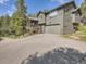 Two-story home with a large garage and inviting facade on a sunny day at 32663 Donna Dr, Conifer, CO 80433