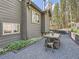 Charming home featuring neutral color siding, outdoor dining area, and well-maintained landscaping at 32663 Donna Dr, Conifer, CO 80433