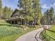 A home's exterior boasts a wrap-around deck with stunning views of the surrounding landscape at 32663 Donna Dr, Conifer, CO 80433