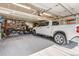 Spacious garage with ample storage and a parked pickup truck at 32663 Donna Dr, Conifer, CO 80433
