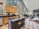 Kitchen with a large island, stainless steel appliances, and an open view to the living room at 32663 Donna Dr, Conifer, CO 80433