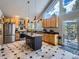 Bright, open kitchen featuring wood cabinets, stainless steel appliances and a large island at 32663 Donna Dr, Conifer, CO 80433