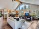 Open-concept living room featuring a kitchen, dining area, and plenty of natural light at 32663 Donna Dr, Conifer, CO 80433