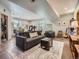 Spacious living room with a comfortable gray sofa, patterned rug, and plenty of natural light at 32663 Donna Dr, Conifer, CO 80433