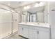 Bathroom features a glass-enclosed shower, double vanity with white cabinets, and modern fixtures at 27534 E Byers Ave, Aurora, CO 80018