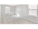 Empty room showcases two windows and neutral carpeting, offering a bright, spacious atmosphere at 27534 E Byers Ave, Aurora, CO 80018