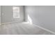 This bedroom offers neutral carpeting, a window, and neutral wall colors at 27534 E Byers Ave, Aurora, CO 80018