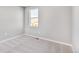 Cozy bedroom features a window allowing for natural light and plush carpeting at 27534 E Byers Ave, Aurora, CO 80018