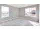Bright bedroom features two windows, neutral walls and plush carpeting, creating a comfortable space at 27534 E Byers Ave, Aurora, CO 80018